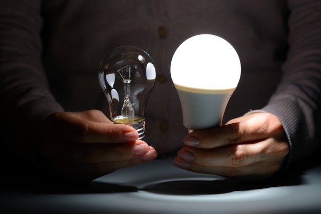 female-hands-holding-glowing-led-incandescent-bulbs-dark_168730-1029
